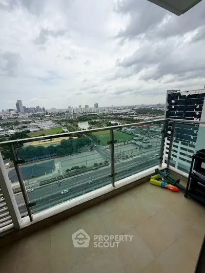 Spacious balcony with stunning cityscape view, perfect for relaxation and enjoying urban living.