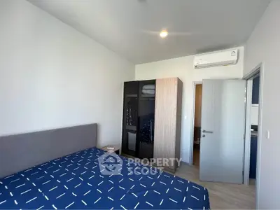 Modern bedroom with stylish wardrobe and air conditioning unit