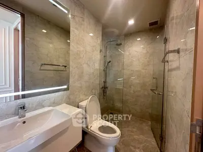 Modern bathroom with glass shower and elegant marble tiles