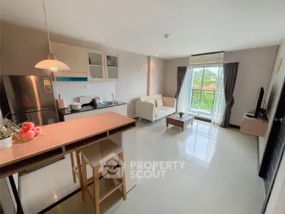 Modern open-layout kitchen and living room with natural light and scenic view.