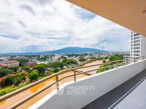 Stunning balcony view overlooking a vibrant cityscape and river, perfect for relaxation and enjoying the scenery.