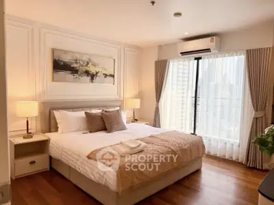 Luxurious bedroom with elegant decor and city view, featuring a cozy bed and stylish lighting.