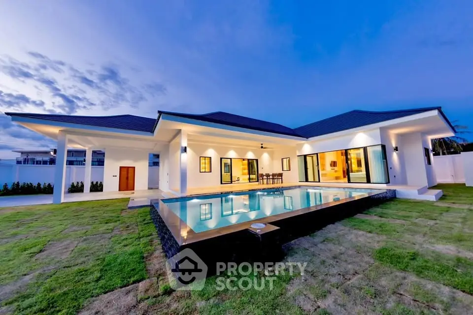 Luxurious modern villa with stunning pool and elegant exterior design at dusk.