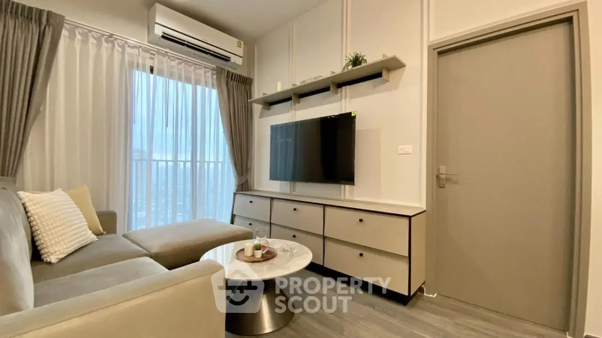 Modern living room with sleek furniture and wall-mounted TV in stylish apartment