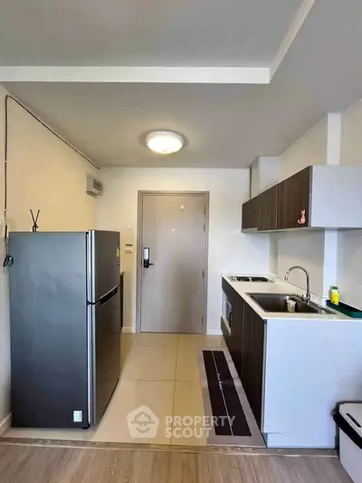 Modern kitchen with sleek cabinetry and stainless steel appliances in a compact layout.