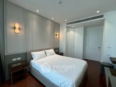 Elegant bedroom with modern lighting and stylish decor in a luxury apartment.