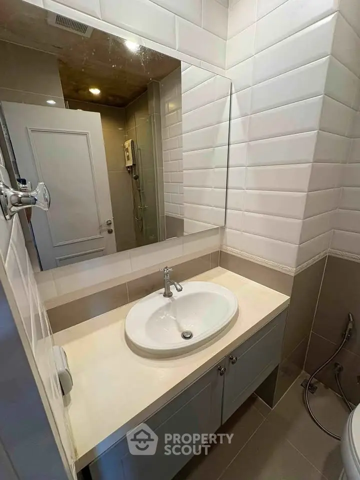 Modern bathroom with sleek sink and stylish tiles, perfect for contemporary living.