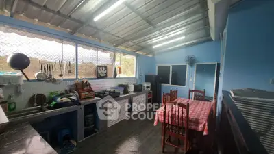 Charming kitchen with open layout and dining area, featuring ample natural light and modern appliances.