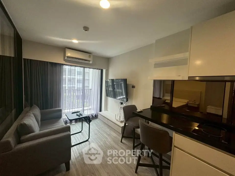 Modern living room with sleek furniture and natural light, perfect for urban living.