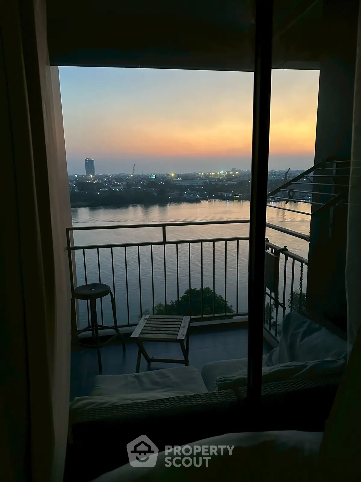 Stunning river view from a cozy balcony at sunset, perfect for relaxation and enjoying serene evenings.