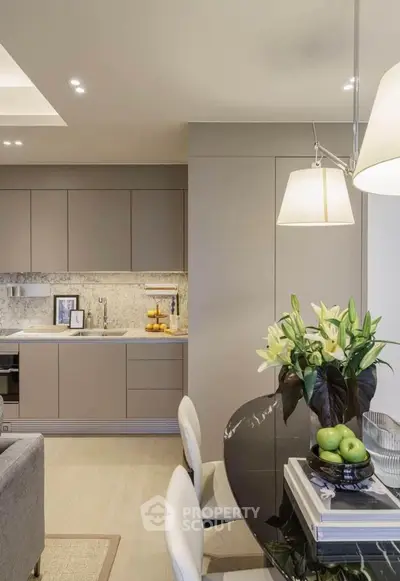 Modern kitchen and dining area with sleek cabinetry and elegant decor