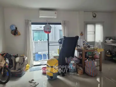 Spacious living room with modern decor and large windows for natural light.