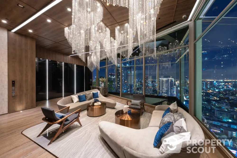 Luxurious high-rise living room with panoramic city views and elegant chandelier lighting.