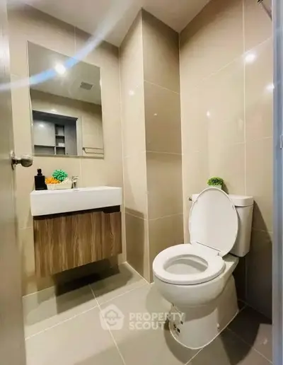 Modern bathroom with sleek fixtures and neutral tiles