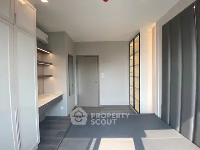 Spacious modern study room with built-in shelves and ample natural light