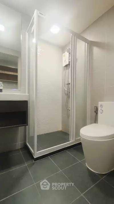Modern bathroom with sleek shower enclosure and contemporary fixtures.
