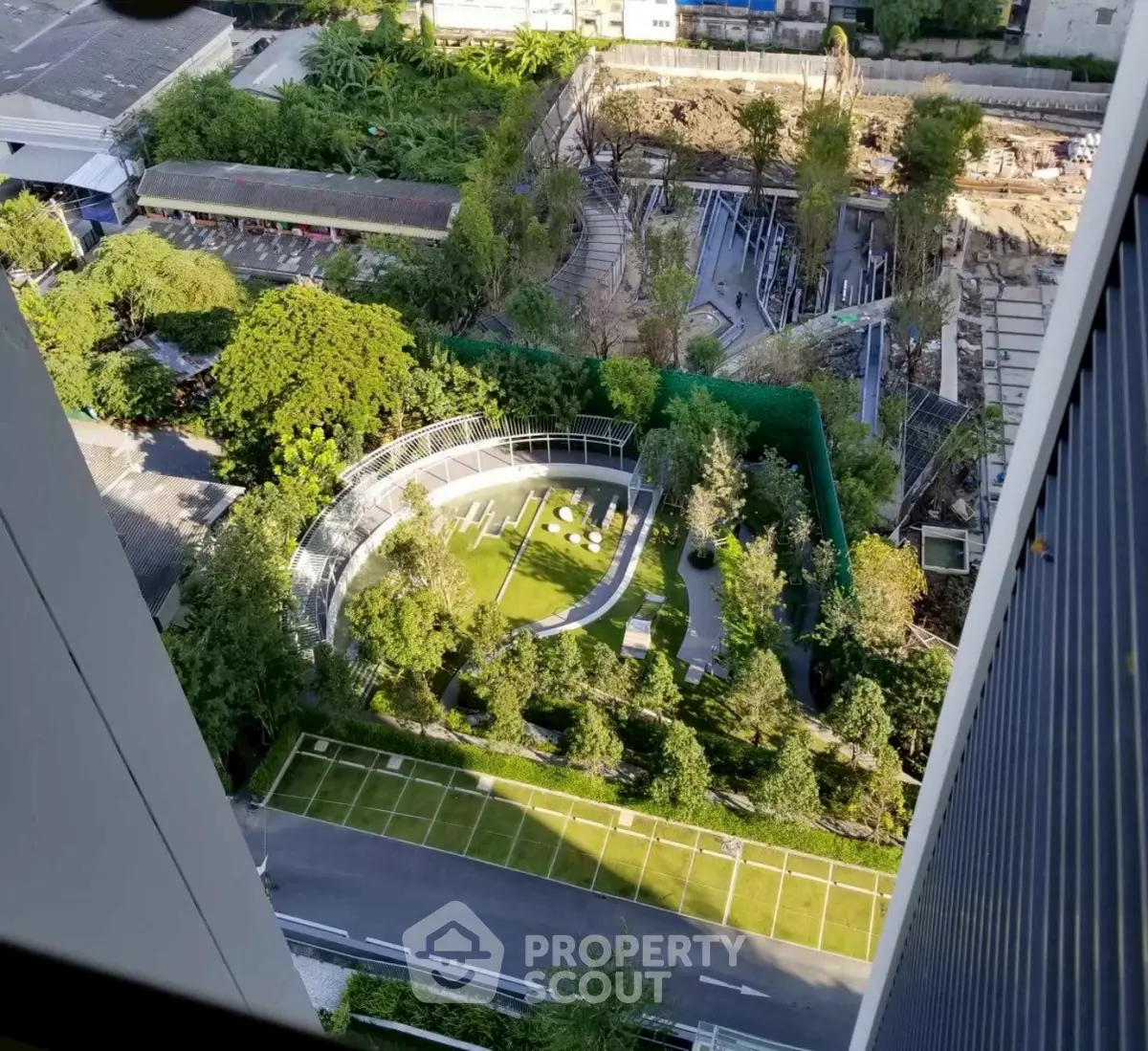 Stunning aerial view of modern urban garden with lush greenery and sleek architectural design.