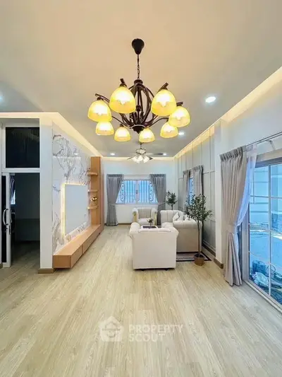 Spacious and elegant living room with modern lighting and cozy seating area.