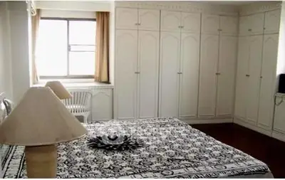 Spacious bedroom with elegant built-in wardrobes and large window for natural light.