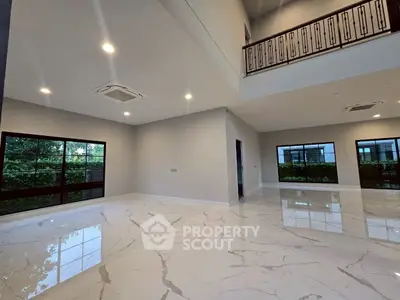 Spacious modern living room with high ceilings and large windows