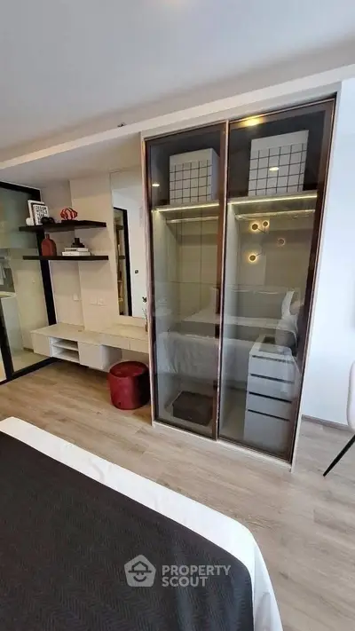 Modern bedroom with sleek glass wardrobe and stylish decor