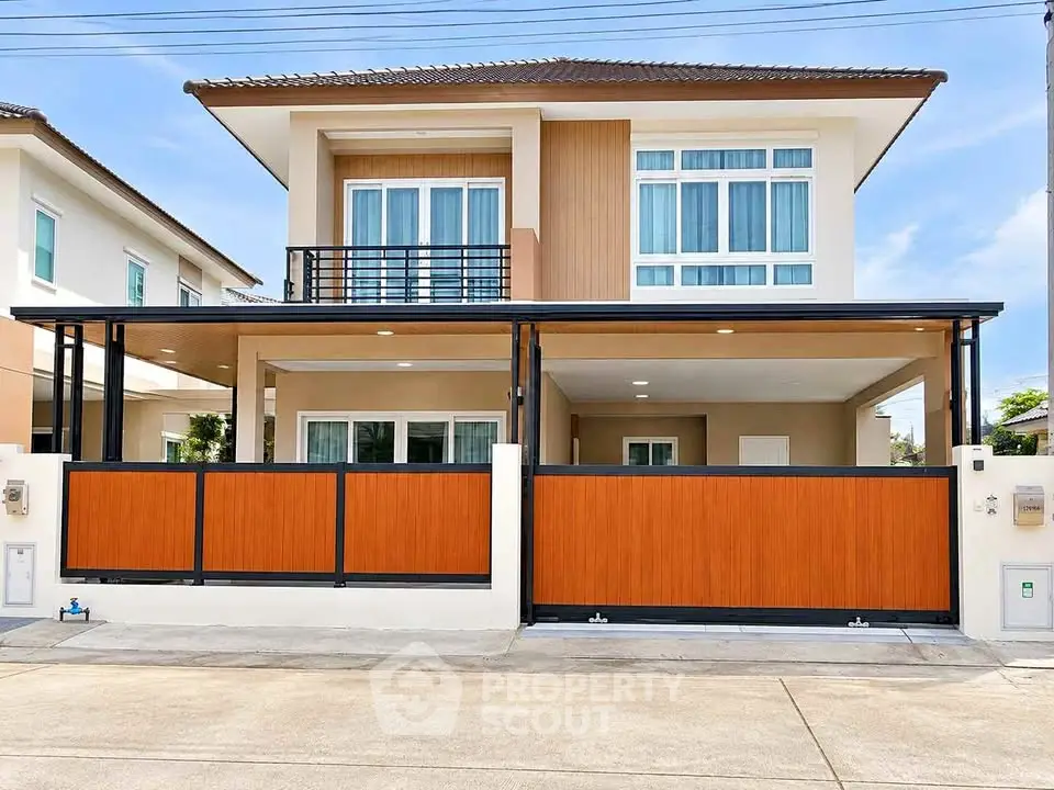 Modern two-story house with sleek design and spacious balcony in a serene neighborhood.