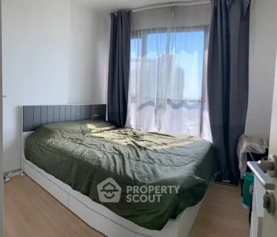 Cozy bedroom with large window and modern decor