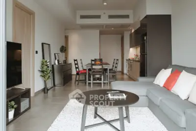 Modern open-plan living room with stylish furniture and dining area, perfect for entertaining.