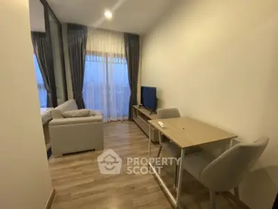 Modern living room with cozy sofa and TV, perfect for relaxation.