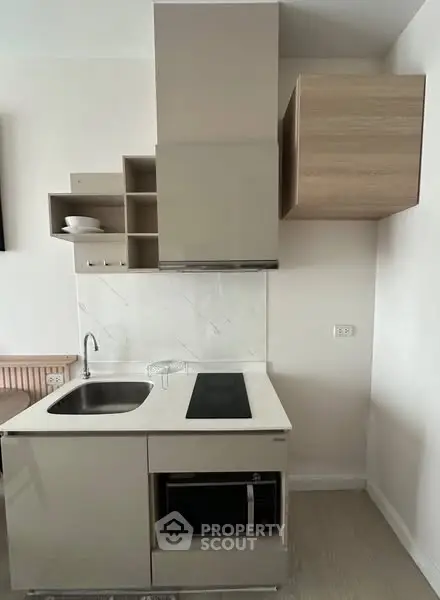Modern compact kitchen with sleek cabinetry and built-in appliances
