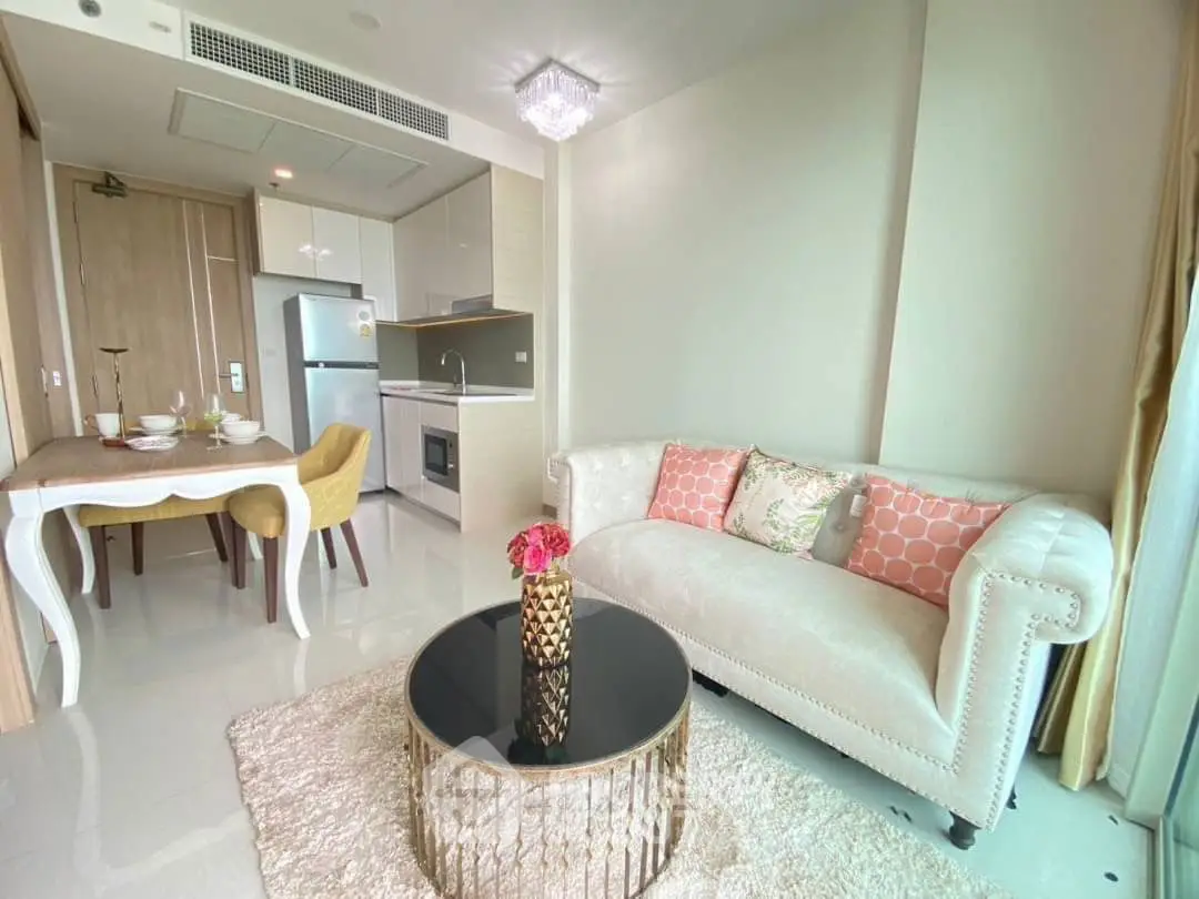 Luxurious living room with elegant decor and modern kitchen in open layout apartment.