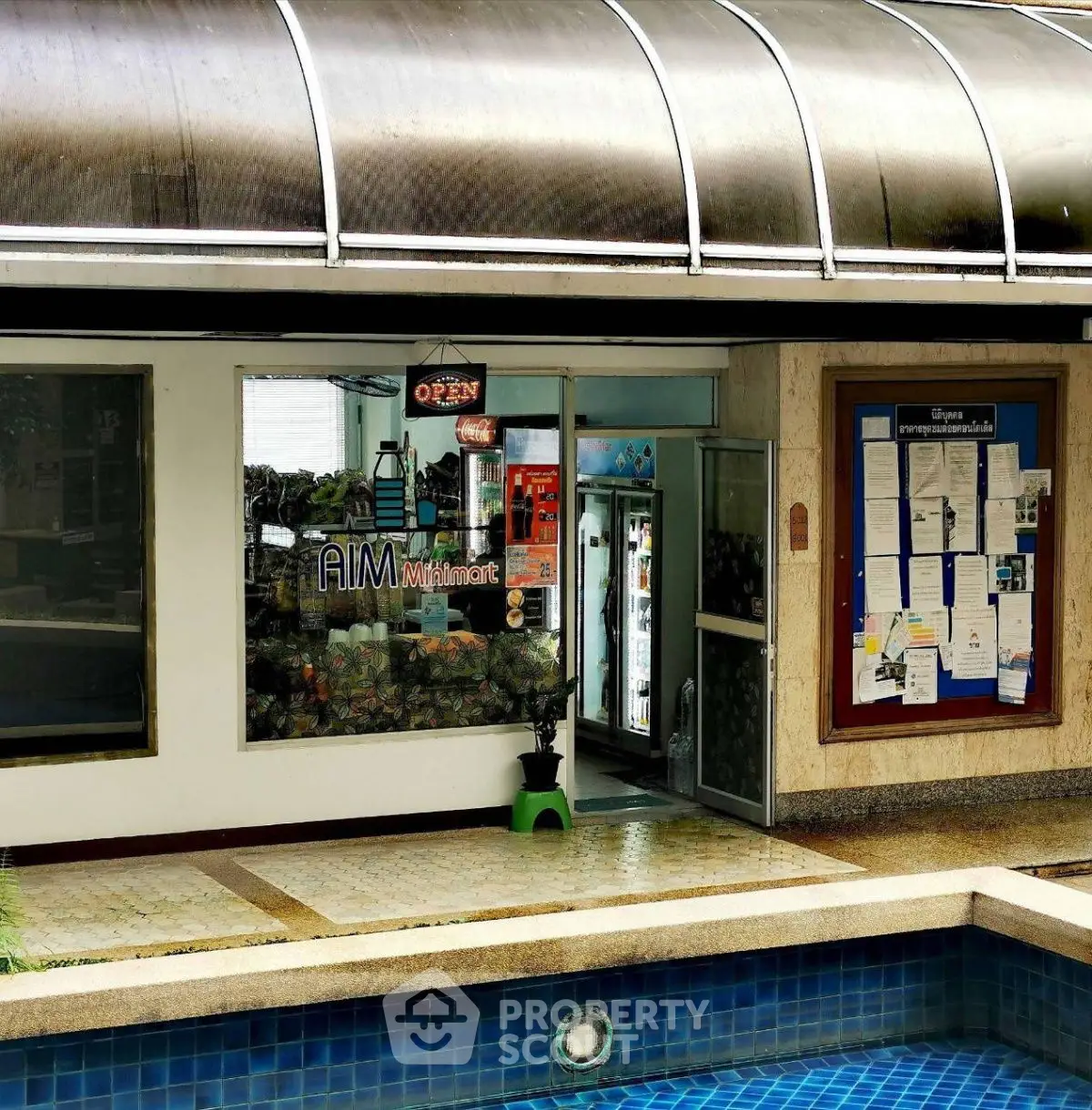 Commercial property with poolside entrance and glass storefront