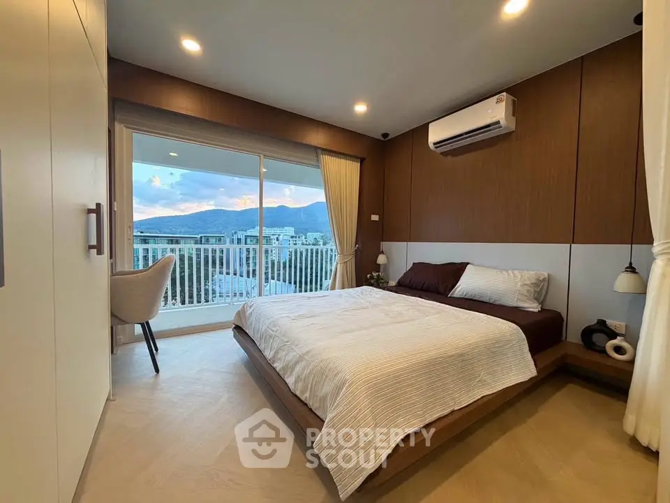 Modern bedroom with mountain view and balcony access
