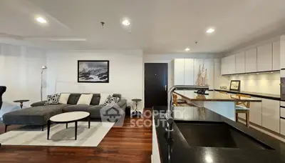 Modern open-plan living room with sleek kitchen and stylish decor