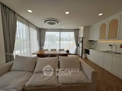 Spacious modern living room with open kitchen and elegant dining area