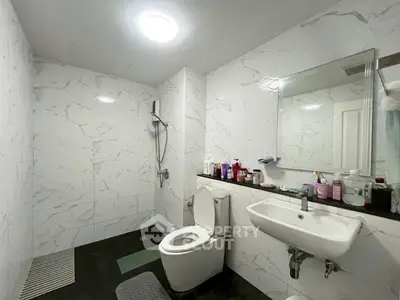 Modern bathroom with sleek white tiles and contemporary fixtures