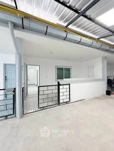 Spacious modern balcony with sleek metal railing and tiled flooring, perfect for relaxation and outdoor activities.