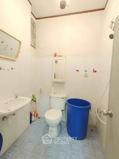 Compact bathroom with essential fixtures and blue accents