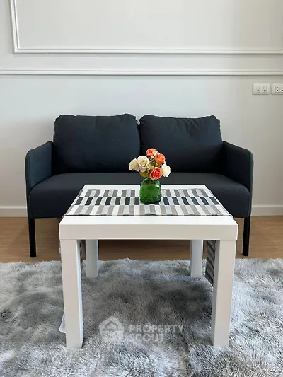 Stylish living room with modern sofa and chic coffee table on plush rug