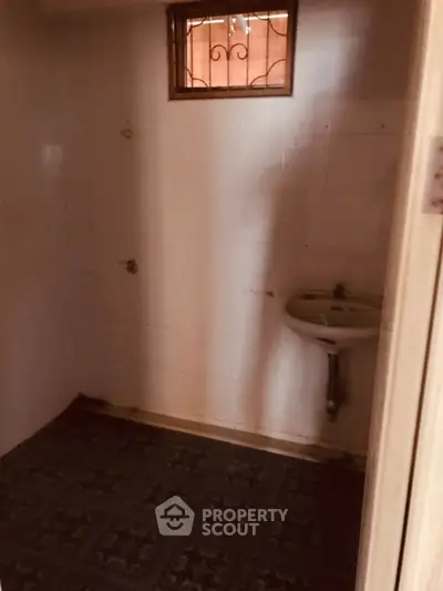 Small bathroom with tiled floor and wall-mounted sink