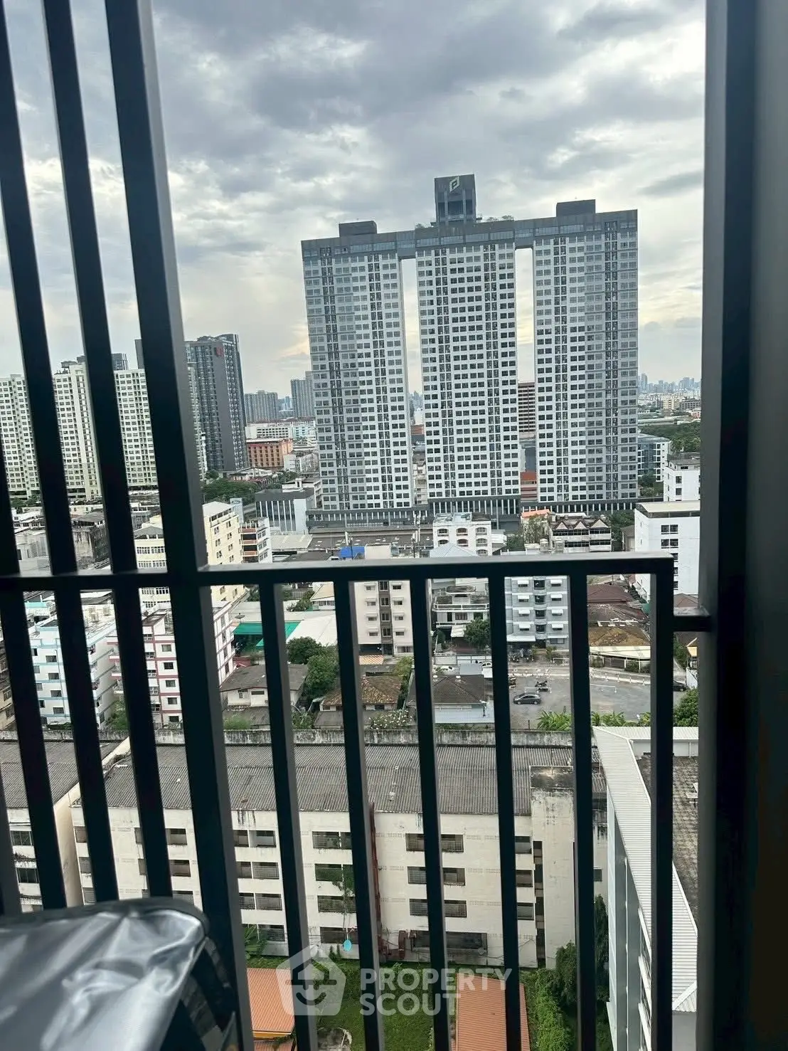 Stunning cityscape view from a high-rise balcony with modern architecture.