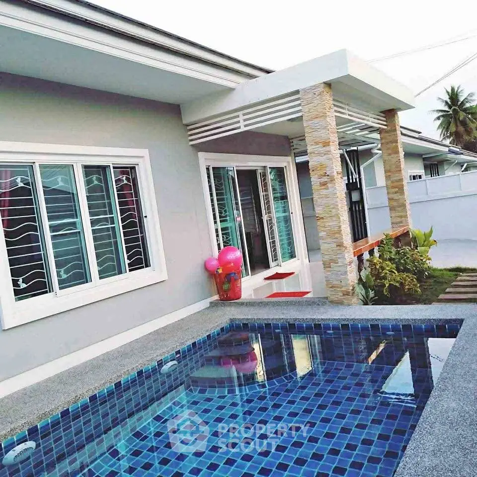 Modern home exterior with private pool and stylish patio area.