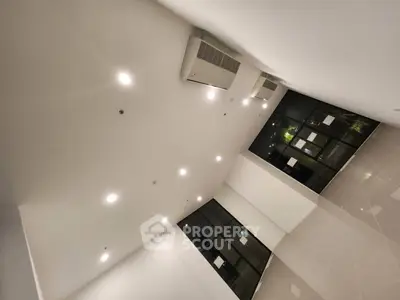 Spacious modern interior with high ceiling and large windows