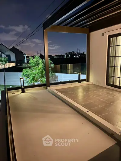 Modern balcony with sleek design and night view, perfect for relaxation and entertainment.
