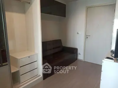 Cozy living room with modern furniture and ample storage space in a stylish apartment.