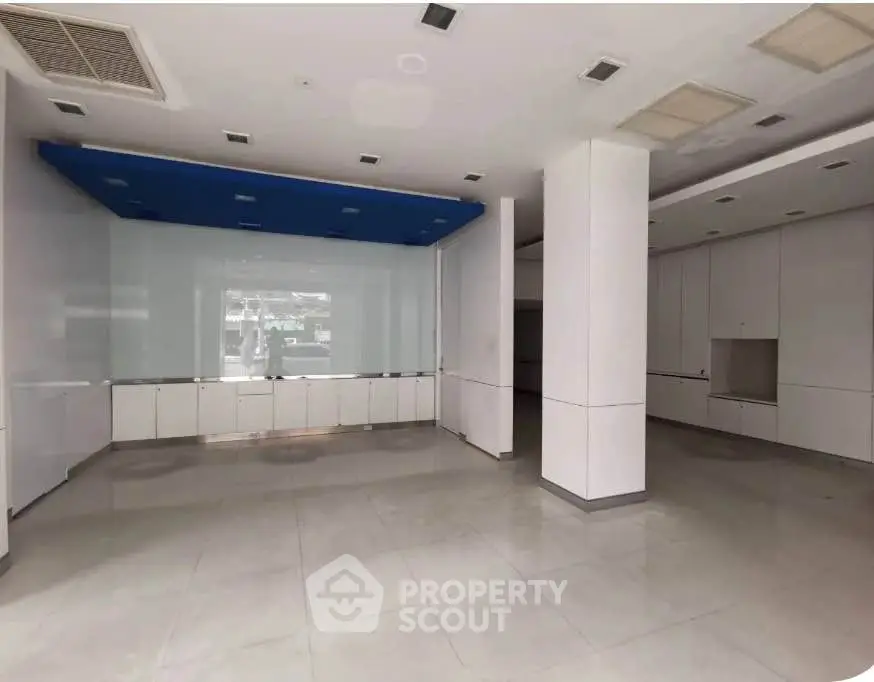 Spacious commercial interior with modern design and ample natural light, ideal for retail or office space.