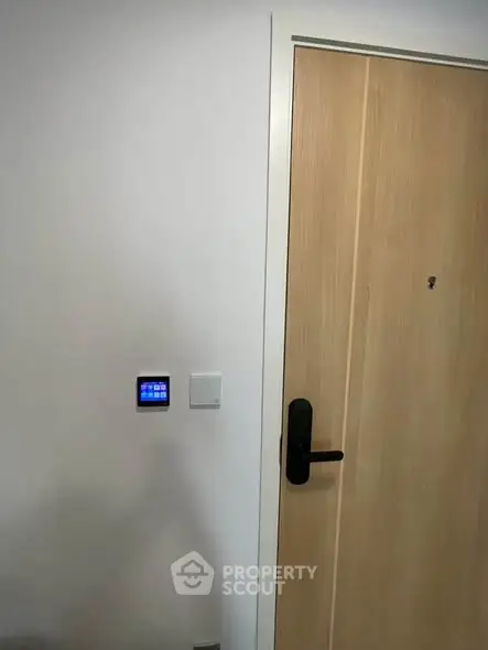 Modern apartment entrance with smart lock and control panel
