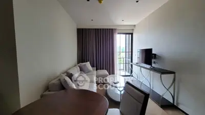 Modern living room with stylish furniture and balcony view in a contemporary apartment.