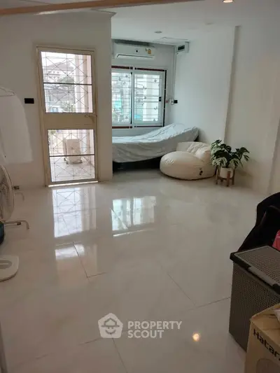 Spacious living room with large windows and modern minimalist decor