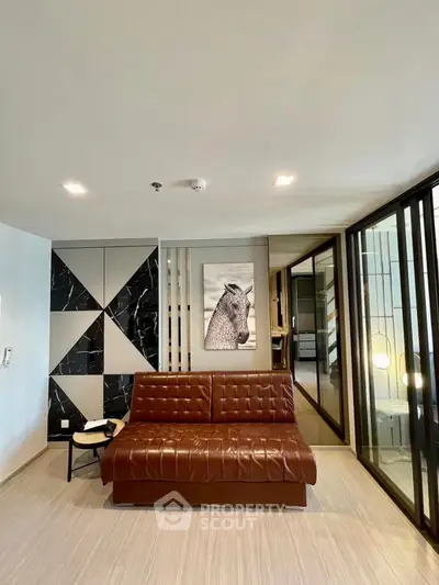 Modern living room with stylish leather sofa and geometric wall art